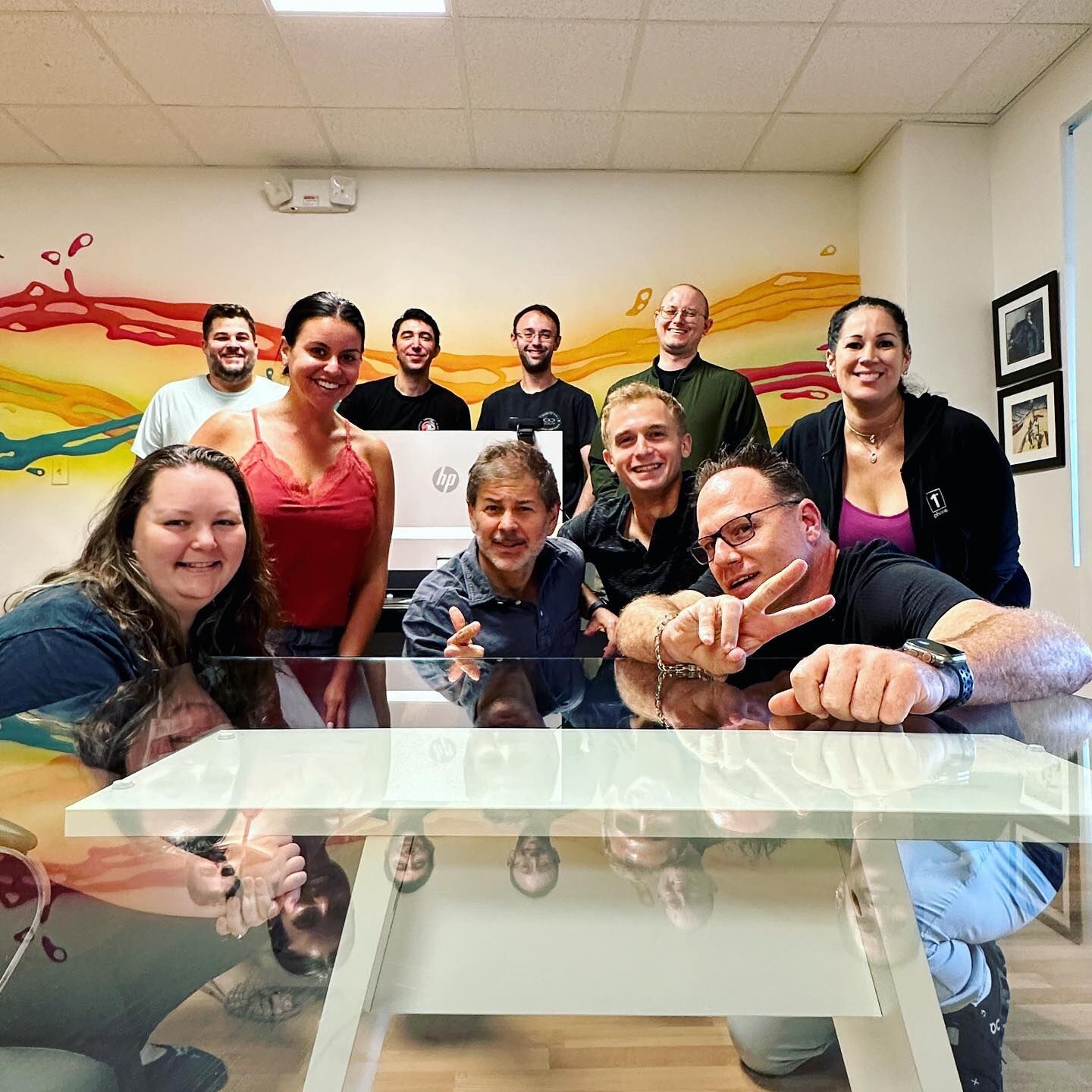 The crew, in front of the mural